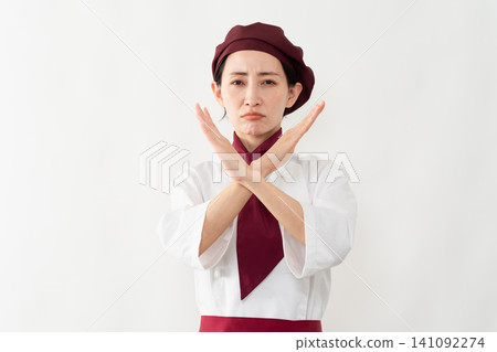A woman wearing a baker's uniform A woman wearing a baker's uniform 141092274