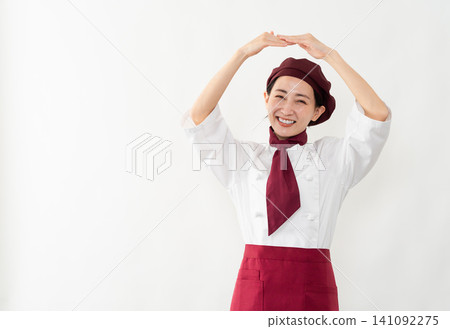 A woman wearing a baker's uniform A woman wearing a baker's uniform 141092275