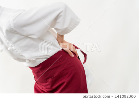 A woman wearing a baker's uniform A woman wearing a baker's uniform 141092300