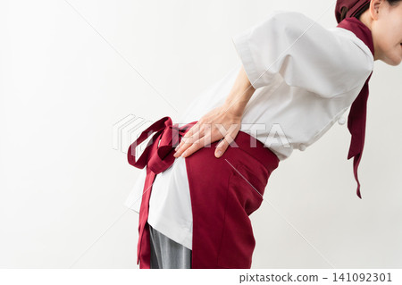 A woman wearing a baker's uniform A woman wearing a baker's uniform 141092301