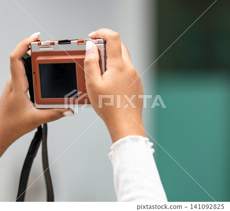 woman hands holding a compact digital camera is taking a photo with copy space. woman hands holding a compact digital camera is taking a photo with copy space. 141092825