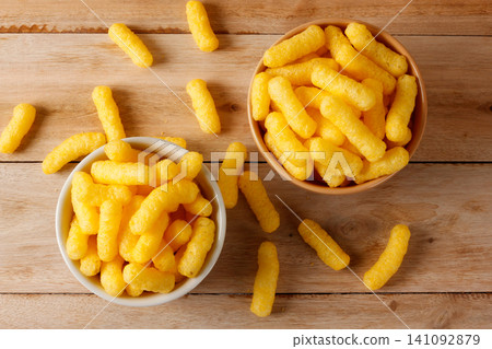 Crispy corn sticks served in two bowls on a rustic wooden table in a top view Crispy corn sticks served in two bowls on a rustic wooden table in a top view 141092879