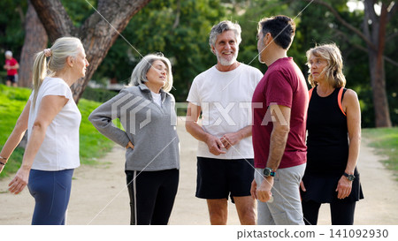Senior group actively talking outdoors after exercise Senior group actively talking outdoors after exercise 141092930
