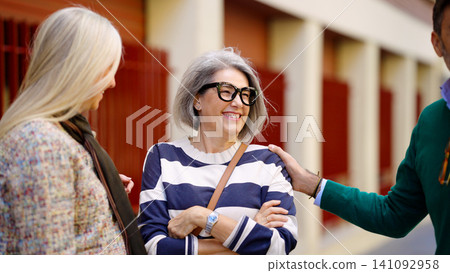 Senior friends laughing together actively socializing outdoors Senior friends laughing together actively socializing outdoors 141092958