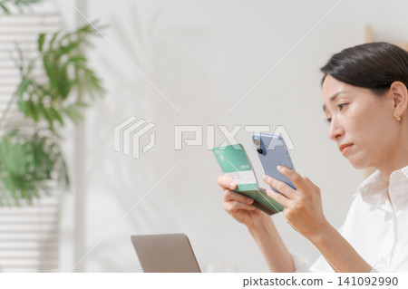 A woman who falls down looking at a passbook A woman who falls down looking at a passbook 141092990