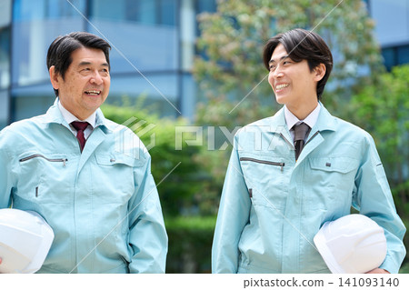 An Asian male worker walking and talking. An Asian male worker walking and talking. 141093140