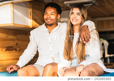 Happy couple embracing freedom on camper van road trip 141093365