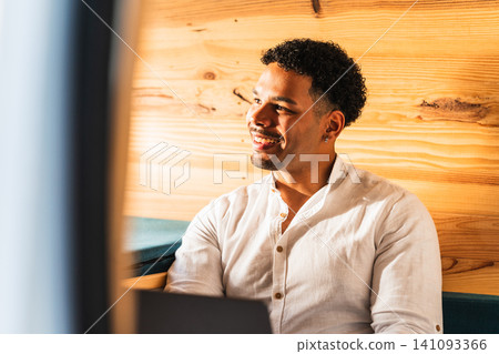 Young man smiling inside camper van looking away Young man smiling inside camper van looking away 141093366
