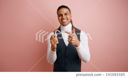 Smiling man presenting clear dental aligners for oral care Smiling man presenting clear dental aligners for oral care 141093385