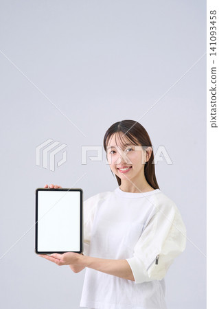 Japanese woman showing tablet screen Japanese woman showing tablet screen 141093458