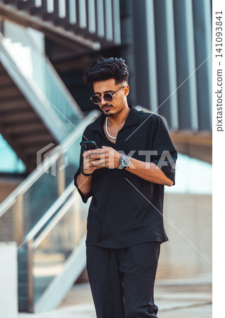 Moroccan man using smartphone in urban setting Moroccan man using smartphone in urban setting 141093841