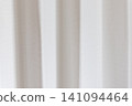 Beautiful white curtain fabric texture background with vertical pleats and soft shadows. 141094464