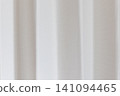 Beautiful white curtain fabric texture background with vertical pleats and soft shadows. 141094465