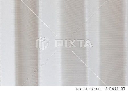 Beautiful white curtain fabric texture background with vertical pleats and soft shadows. Beautiful white curtain fabric texture background with vertical pleats and soft shadows. 141094465