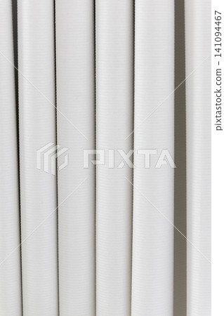 Beautiful white curtain fabric texture background with vertical pleats and soft shadows. Beautiful white curtain fabric texture background with vertical pleats and soft shadows. 141094467
