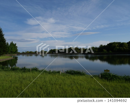 The blue sky reflected in the reservoir The blue sky reflected in the reservoir 141094692