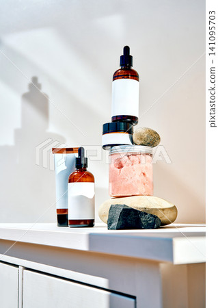 Skincare product bottles balancing on natural stones Skincare product bottles balancing on natural stones 141095703
