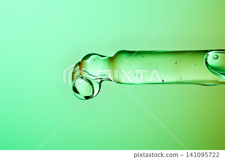 Adaptive skincare serum pipette dropping green liquid Adaptive skincare serum pipette dropping green liquid 141095722