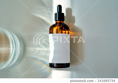 Biotech serum dropper bottle creating light refraction Biotech serum dropper bottle creating light refraction 141095734