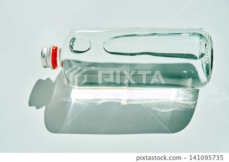 Glass bottle on side showing water and bubbles Glass bottle on side showing water and bubbles 141095735