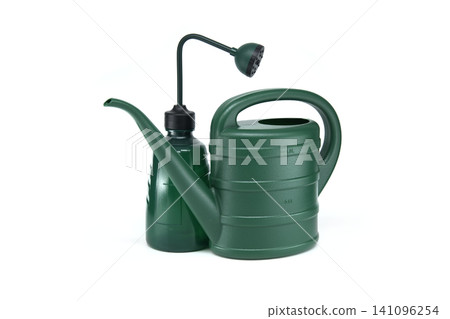 Two green watering cans, one with a long spout and one with a shower head, on white Two green watering cans, one with a long spout and one with a shower head, on white 141096254