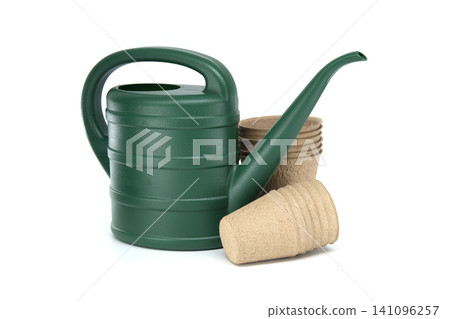 Green watering can with biodegradable seed starting pots for gardening Green watering can with biodegradable seed starting pots for gardening 141096257