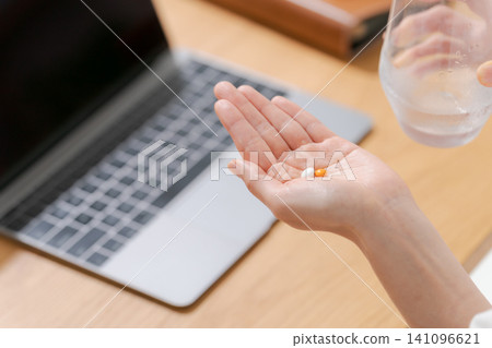Hands of women taking medicine Hands of women taking medicine 141096621