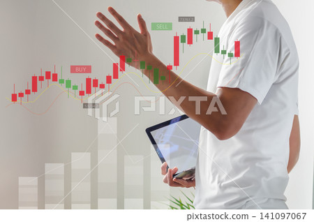 A man holding a tablet and a stock price chart – an investment image. A man holding a tablet and a stock price chart – an investment image. 141097067