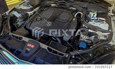 Mercedes V6 Engine Bay Under Open Hood Showing Car Motor Components and all engine mechanical 141097217