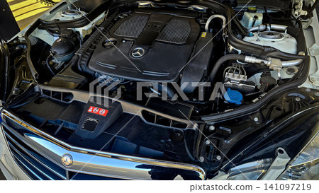 Mercedes V6 Engine Bay Under Open Hood Showing Car Motor Components and all engine mechanical Mercedes V6 Engine Bay Under Open Hood Showing Car Motor Components and all engine mechanical 141097219
