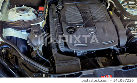 Mercedes V6 Engine Bay Under Open Hood Showing Car Motor Components and all engine mechanical Mercedes V6 Engine Bay Under Open Hood Showing Car Motor Components and all engine mechanical 141097226