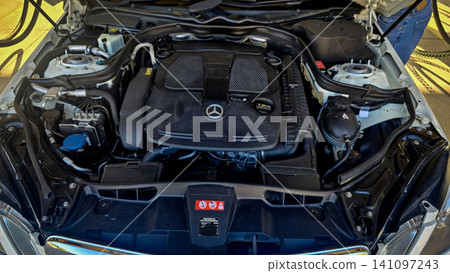 Mercedes V6 Engine Bay Under Open Hood Showing Car Motor Components and all engine mechanical Mercedes V6 Engine Bay Under Open Hood Showing Car Motor Components and all engine mechanical 141097243