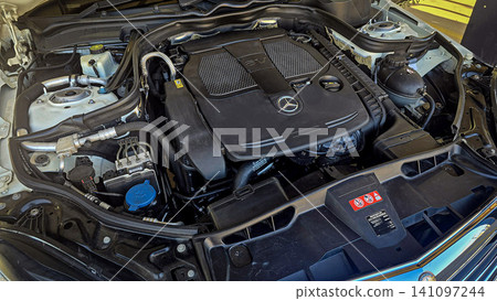 Mercedes V6 Engine Bay Under Open Hood Showing Car Motor Components and all engine mechanical Mercedes V6 Engine Bay Under Open Hood Showing Car Motor Components and all engine mechanical 141097244