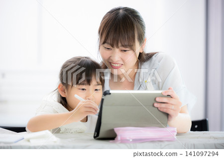 A mother and her elementary school daughter learning together using a tablet - A lifestyle of parent-child learning at home A mother and her elementary school daughter learning together using a tablet - A lifestyle of parent-child learning at home 141097294