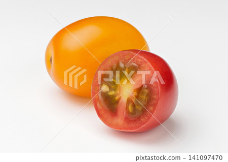 Yellow and red cherry tomatoes lined up against a white background. Yellow and red cherry tomatoes lined up against a white background. 141097470