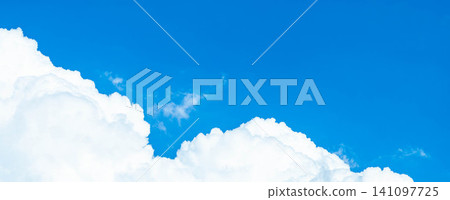 A simple, summery scene with a contrast between the blue summer sky and towering cumulonimbus clouds. A simple, summery scene with a contrast between the blue summer sky and towering cumulonimbus clouds. 141097725