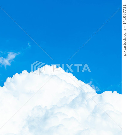 A simple, summery scene with a contrast between the blue summer sky and towering cumulonimbus clouds. A simple, summery scene with a contrast between the blue summer sky and towering cumulonimbus clouds. 141097731