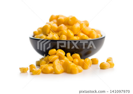 Close-Up Bowl Of Sweet Corn Kernels Spilling On White Surface For Food And Recipes 141097970