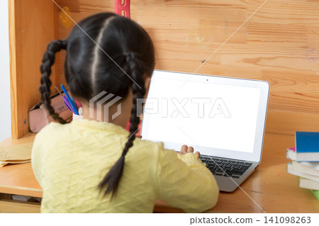 cheerful Asian girl using laptop for online class at home, distance learning and e-education concept. 141098263