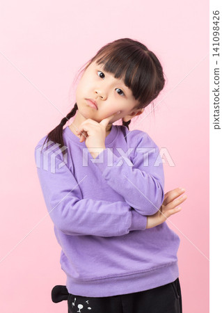 Asian little girl thinking with finger on face curious child expression 141098426