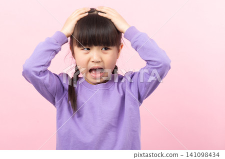 Frustrated Asian girl shouting and holding head stressed child concept Frustrated Asian girl shouting and holding head stressed child concept 141098434