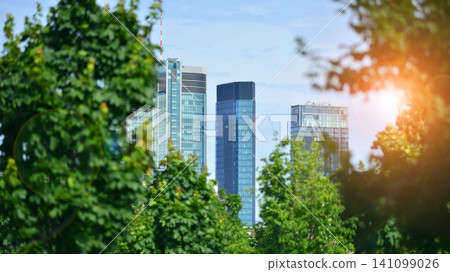 Building surrounded with green trees. Eco-friendly building. Sustainable architecture of city reducing heat carbon dioxide modern city environment. Building surrounded with green trees. Eco-friendly building. Sustainable architecture of city reducing heat carbon dioxide modern city environment. 141099026