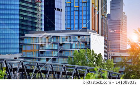 Building surrounded with green trees. Eco-friendly building. Sustainable architecture of city reducing heat carbon dioxide modern city environment. Building surrounded with green trees. Eco-friendly building. Sustainable architecture of city reducing heat carbon dioxide modern city environment. 141099032