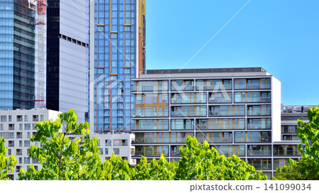 Building surrounded with green trees. Eco-friendly building. Sustainable architecture of city reducing heat carbon dioxide modern city environment. Building surrounded with green trees. Eco-friendly building. Sustainable architecture of city reducing heat carbon dioxide modern city environment. 141099034