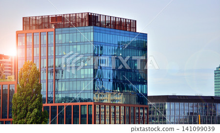 Building surrounded with green trees. Eco-friendly building. Sustainable architecture of city reducing heat carbon dioxide modern city environment. Building surrounded with green trees. Eco-friendly building. Sustainable architecture of city reducing heat carbon dioxide modern city environment. 141099039