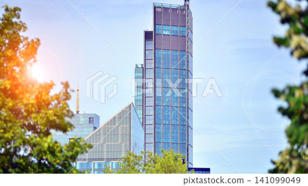Building surrounded with green trees. Eco-friendly building. Sustainable architecture of city reducing heat carbon dioxide modern city environment. Building surrounded with green trees. Eco-friendly building. Sustainable architecture of city reducing heat carbon dioxide modern city environment. 141099049