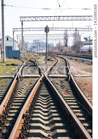 Railway junction tracks in the city with track bed. Gravel and switch at a railroad crossing. Railway junction tracks in the city with track bed. Gravel and switch at a railroad crossing. 141099169