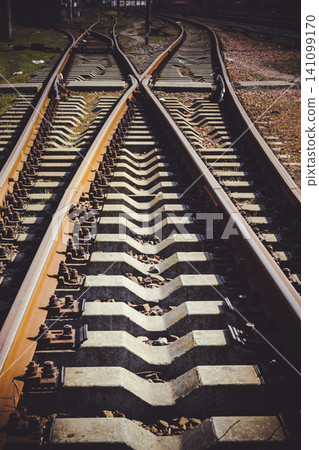 Railway junction tracks in the city with track bed. Gravel and switch at a railroad crossing. Railway junction tracks in the city with track bed. Gravel and switch at a railroad crossing. 141099170