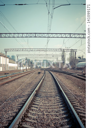 Railway tracks in the city with track bed. Gravel and switch at a railroad crossing. Railway tracks in the city with track bed. Gravel and switch at a railroad crossing. 141099171