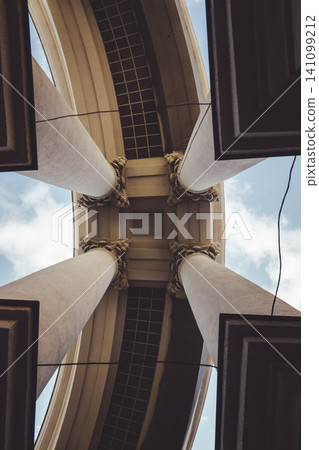 Portico of the building of the Ministry of Foreign Affairs. View from below on the columns of the portico of the Ministry of Foreign. In the middle of four columns Portico of the building of the Ministry of Foreign Affairs. View from below on the columns of the portico of the Ministry of Foreign. In the middle of four columns 141099212